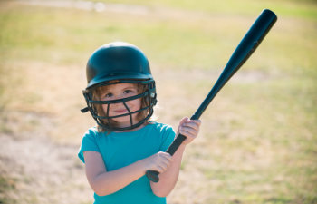 kid holding a baseball bat